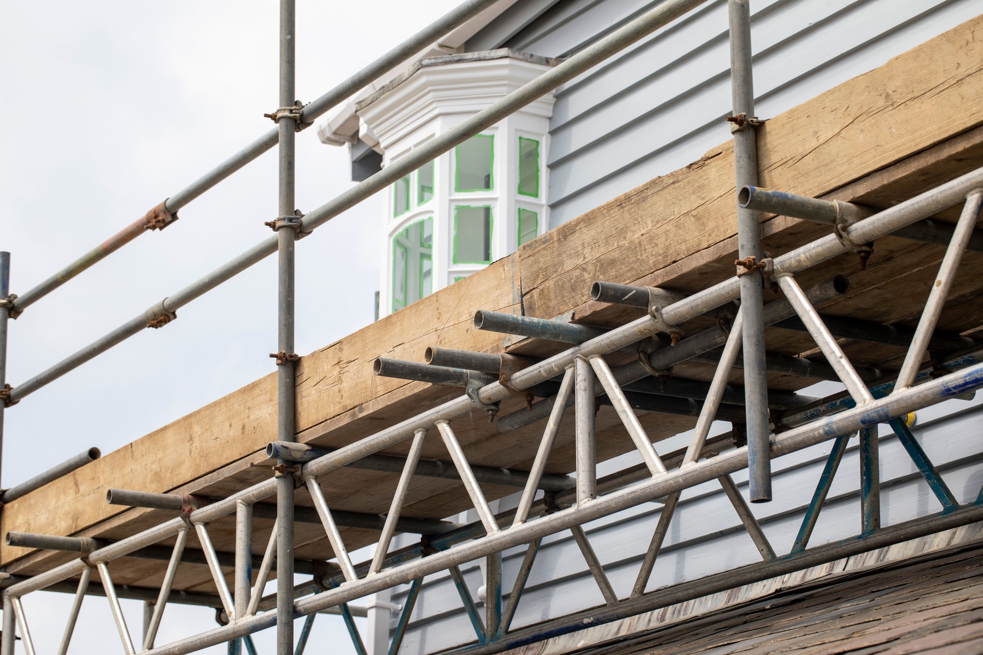 Close-up of scaffolding around a timber building
